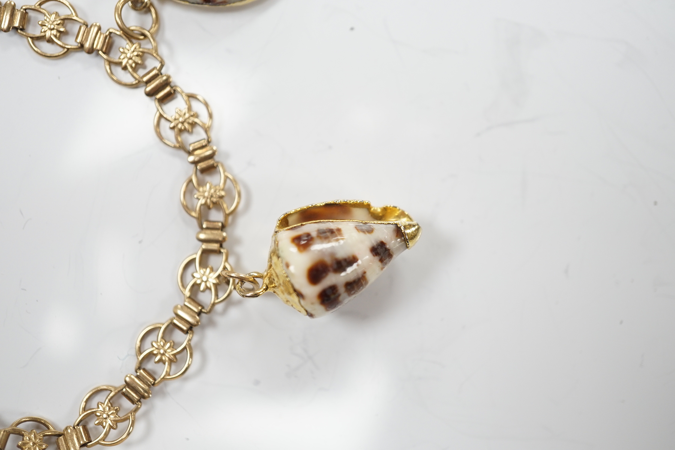 A modern 9ct gold charm bracelet hung with four shell charms, gross weight 19.1 grams.